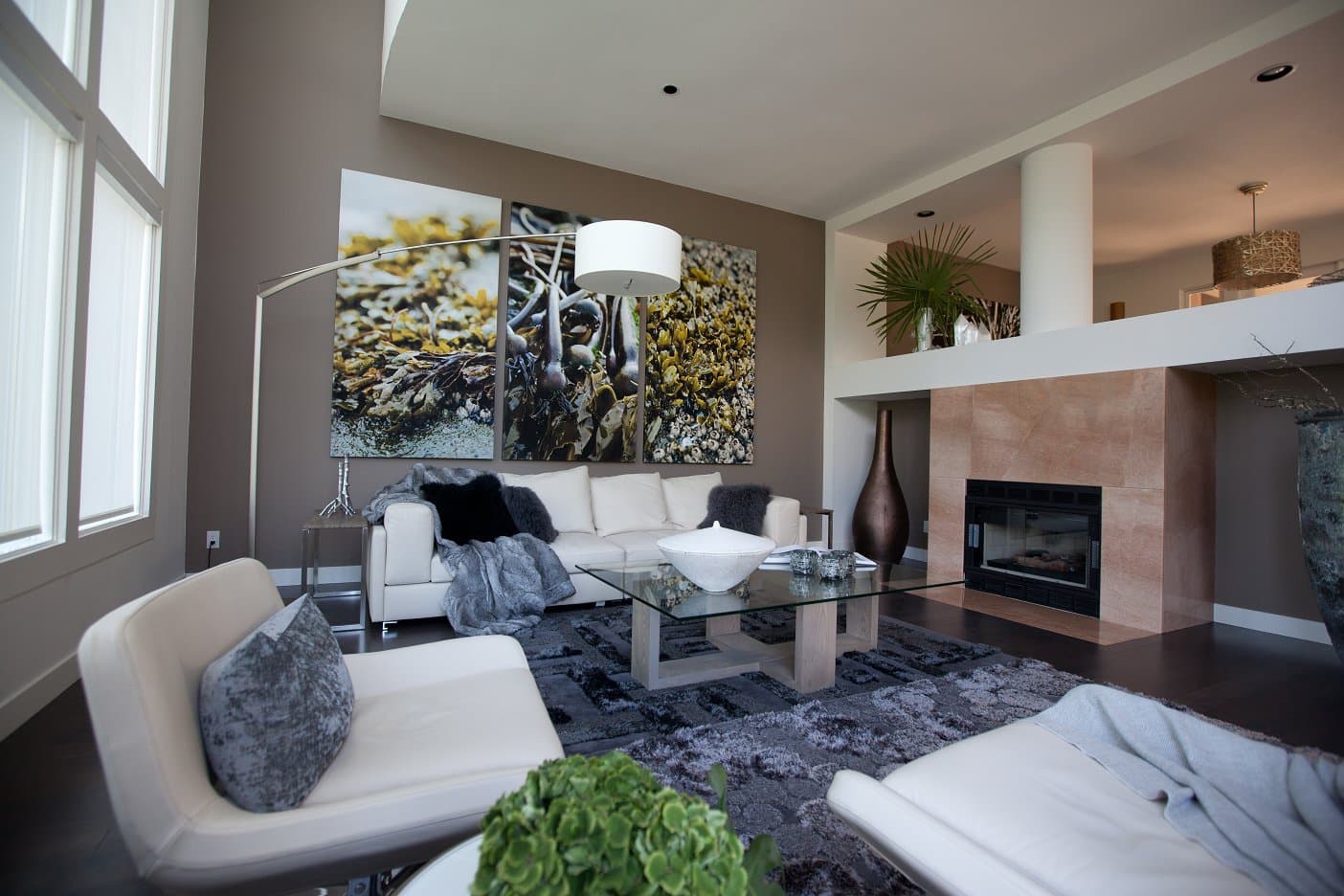 Townhouse renovation in West Vancouver — living room wall flowing up and over a railing into the upstairs office and dining room.